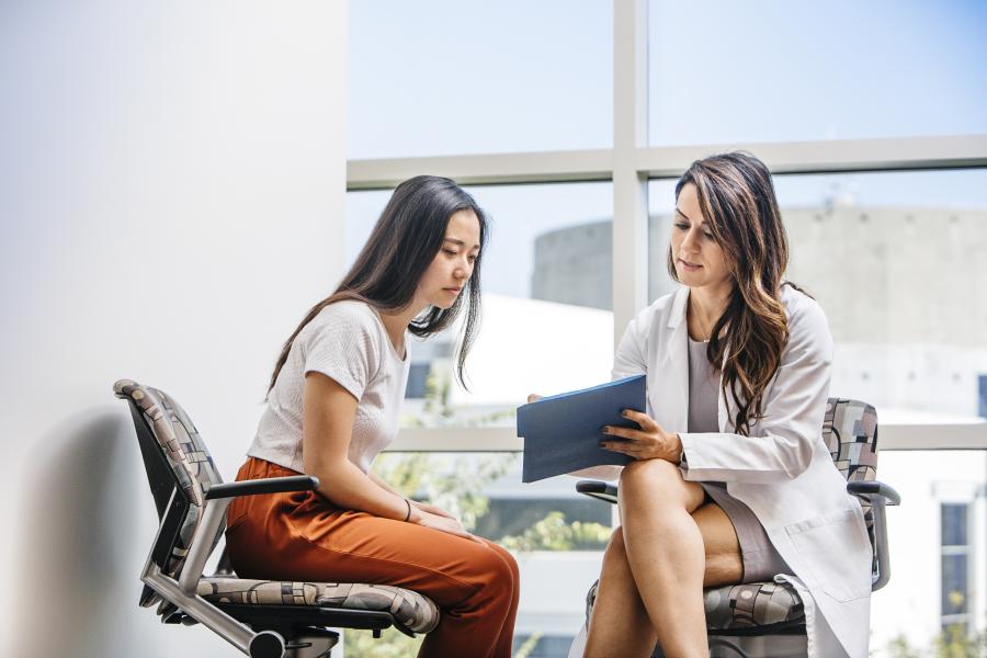 Specialist reviewing information with patient on an ipad